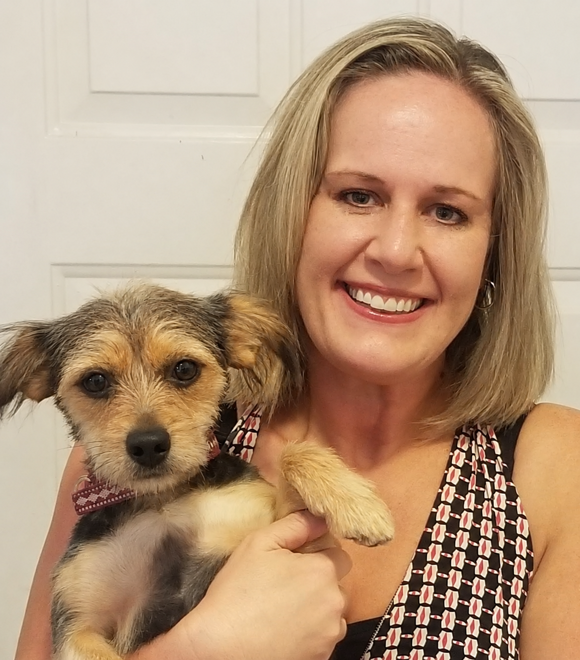Stacie Lumsden Long smiling while holding her happy dog